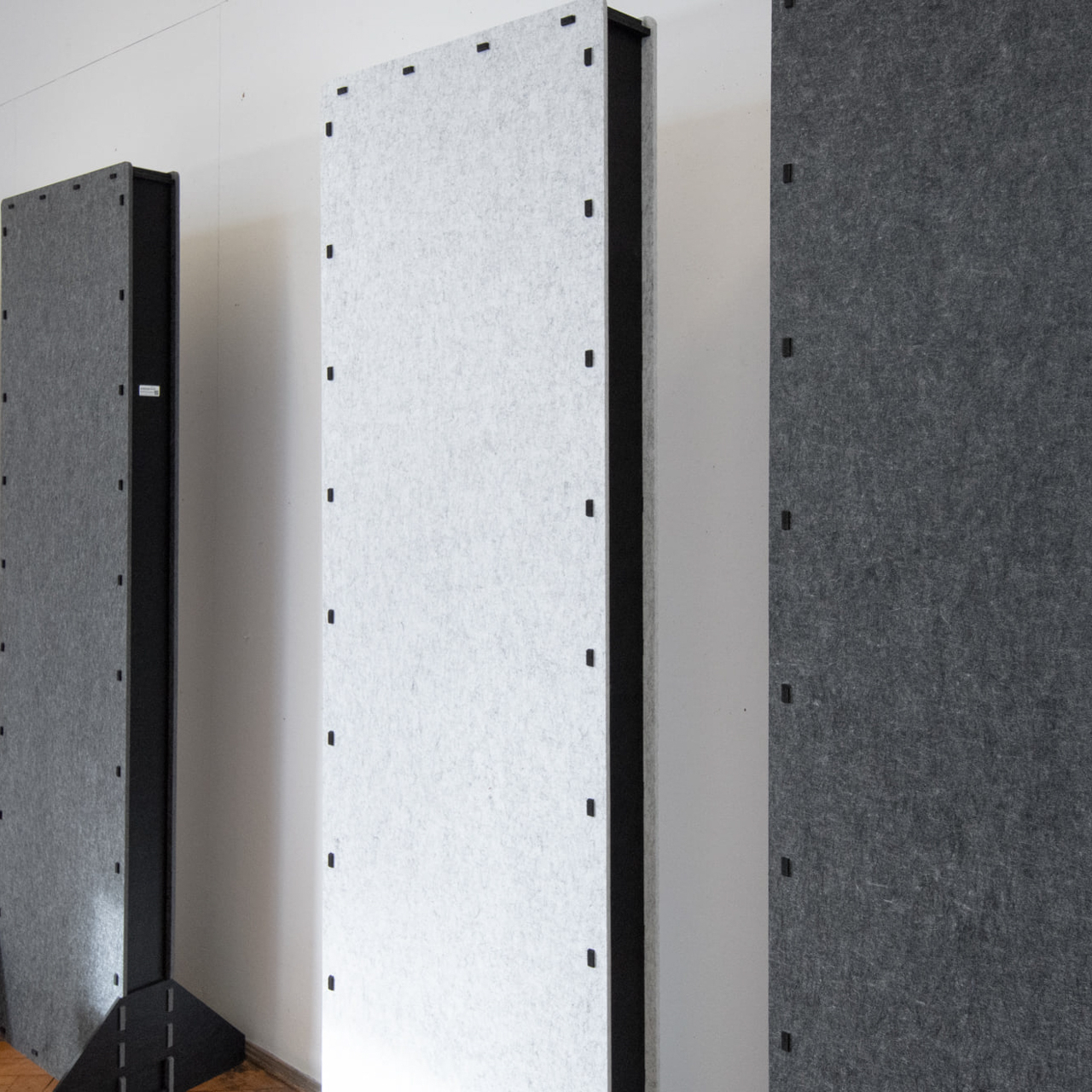 Freestanding sound absorbing acoustic partitions placed against the wall in the lecture room at the Academy of Fine Arts in Krakow to reduce noise and reverberation.
